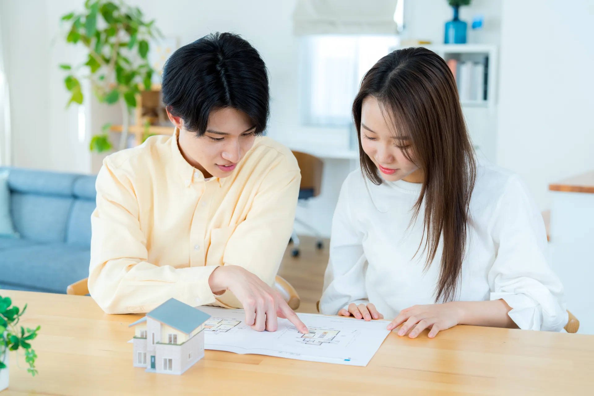 間取り図を見ながら家づくりの計画を立てる夫婦